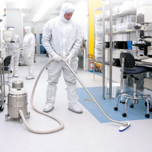 A man in a clean room using the IVT 1000 CR vacuum